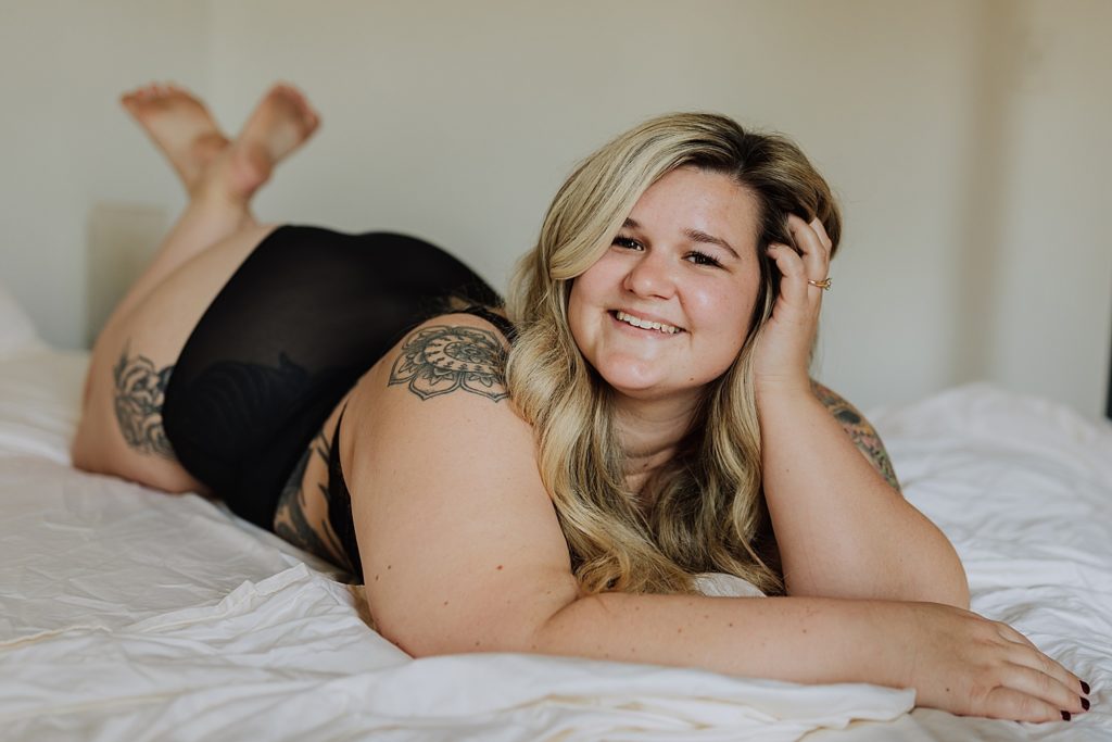 woman laying on bed smiling 